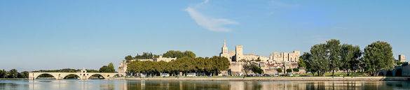 A panorama of the city of Avignon: Pont d’Avignon can be seen to the left and the Rhône River in the foreground