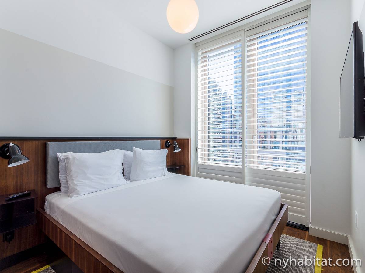 One of the bedrooms in this Midtown West furnished rental with views of New York City. (Rental ID: NY-18034)