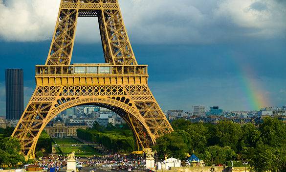 Picture of rainclouds and a rainbow behind the Eiffel Tower in Paris