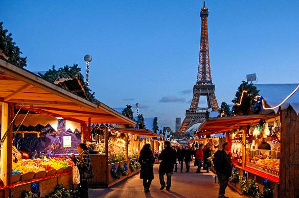 Picture of the Eiffel Tower and a Christmas market. Photo by Jean-Pierre Dalbéra.