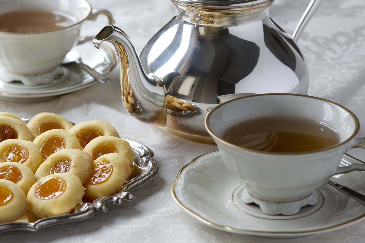 Image of traditional English afternoon tea with cookies, teacup, saucer and teapot