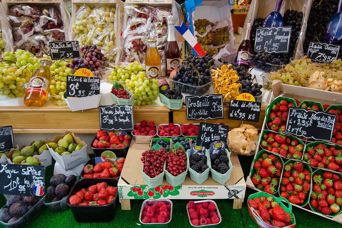 Image of a table laden with berries, grapes and other fruits at a French market