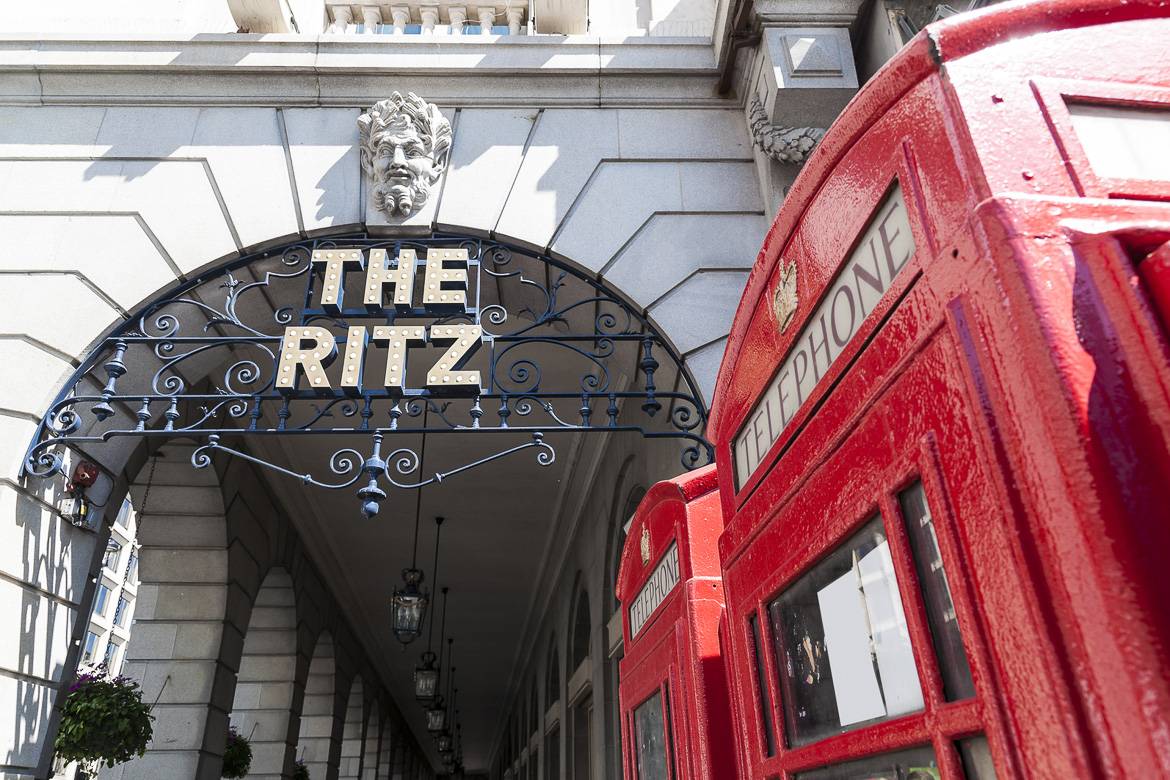 Image of a red telephone booth outside the entrance to the Ritz London