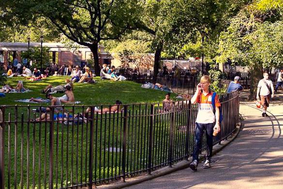 Image of sunbathers and pedestrians in Tompkins Square Park