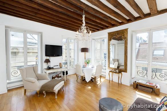 Image of apartment PA-3783 living room’s corner view with chandelier and wood beam ceiling