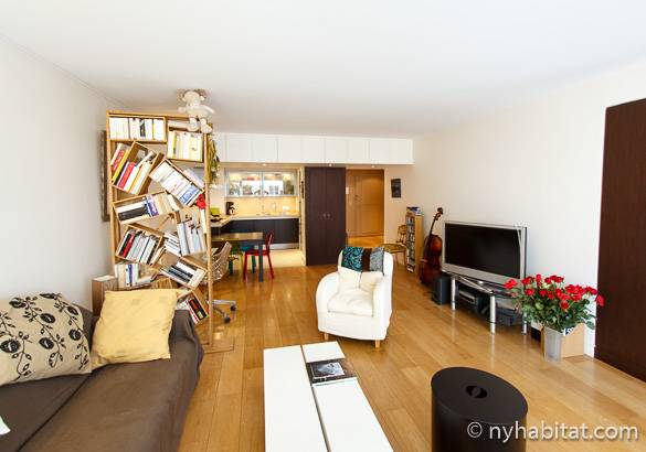 Image of living room of apartment PA-3808 with asymmetrical bookcase and flat screen TV