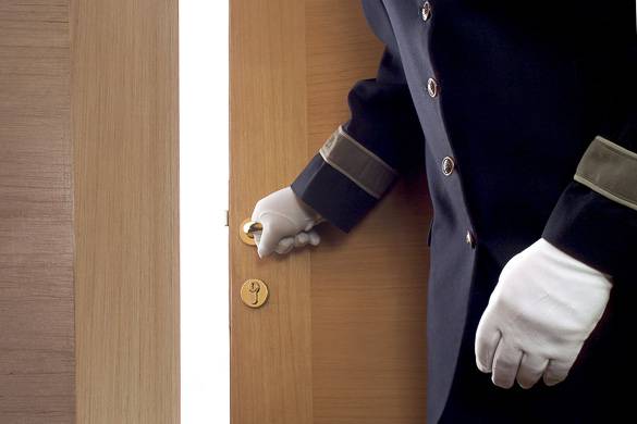 Image of a doorman opening a door