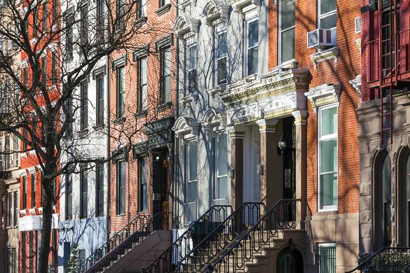 Image of the front stoops of row house buildings in NYC