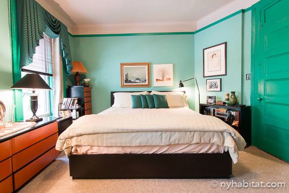 Image of bed in bedroom with green walls of apartment NY-4968