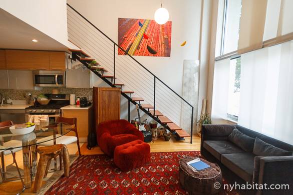 Image of living room of NY-15911 with staircase and wall of windows
