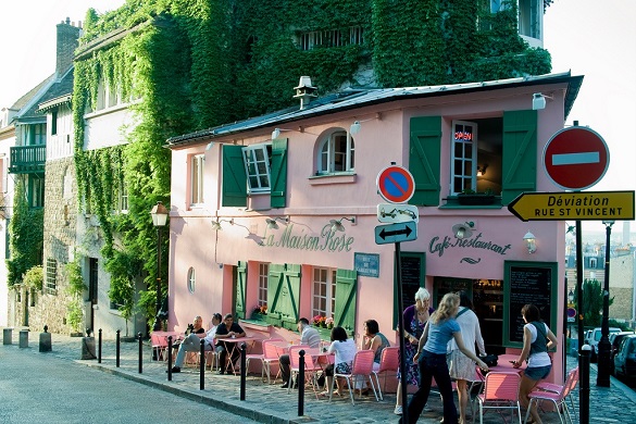 Image of La Maison Rose in Springtime, a pink colored restaurant on a corner in Montmartre