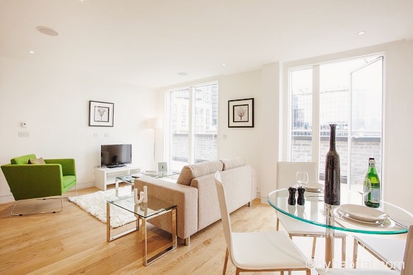Image of living room and dining table of LN-1492 with large windows and balcony in the background