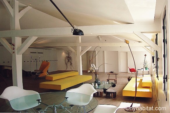 Image of open loft living room of PA-1516 with white walls and modern yellow sofas