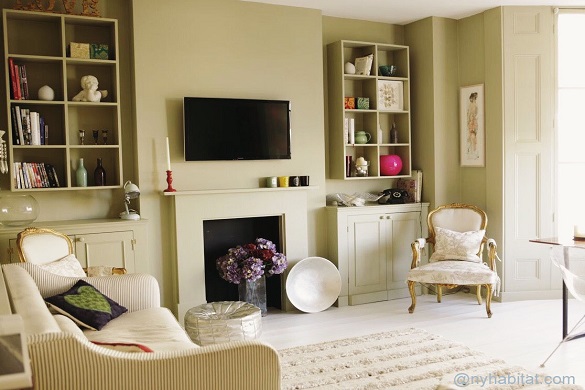 Image of living room of LN-1185 with decorative fireplace, couch and armchair