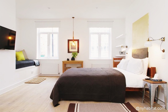 Image of bed with window and seating area in studio LN-1560