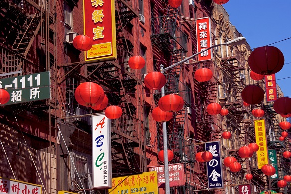 Image of signs written in Chinese and Chinese lanterns in Chinatown NYC