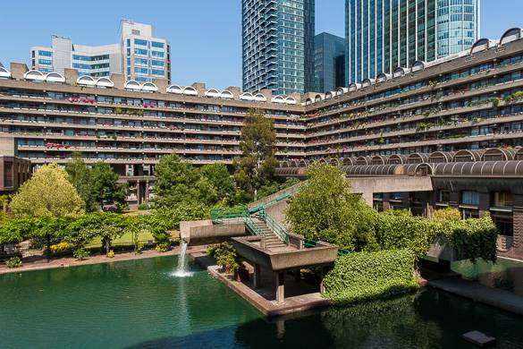 Image of the view of two wings of the Barbican Centre, with a pond in the foreground