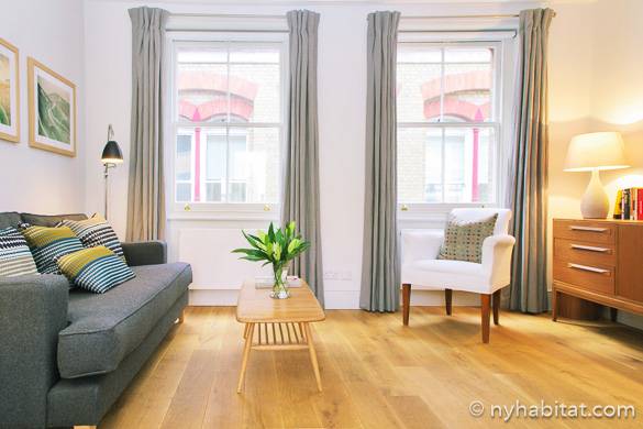 Image of the spacious living room in NY-1818 with light wooden flooring