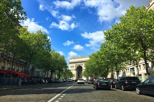 Image of the Arc de Triomphe at the end of a tree-lined street