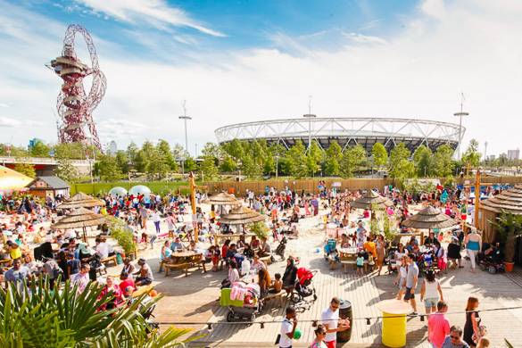 Image of Beach East amusement park with rides and outdoor dining tables