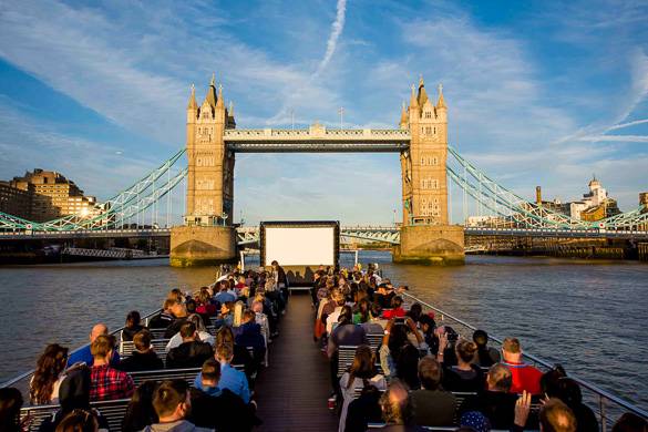 Image of a boat with an outdoor movie screen on top