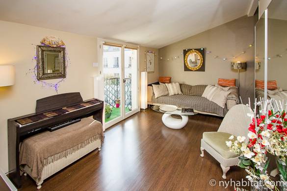 Image of living room of PA-3708 in the Marais with wood floors, sloped ceilings and balcony