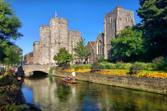 Image of a boat on the river in Canterbury with historic building in the backdrop