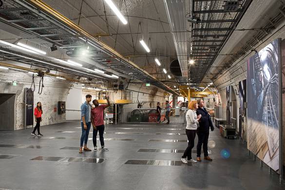 Image of people admiring artwork in the engineering depot at the Postal Museum