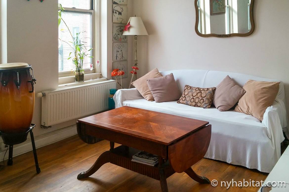 Image of living room of NY-14846 with sofa, coffee table, dining table and standing drum