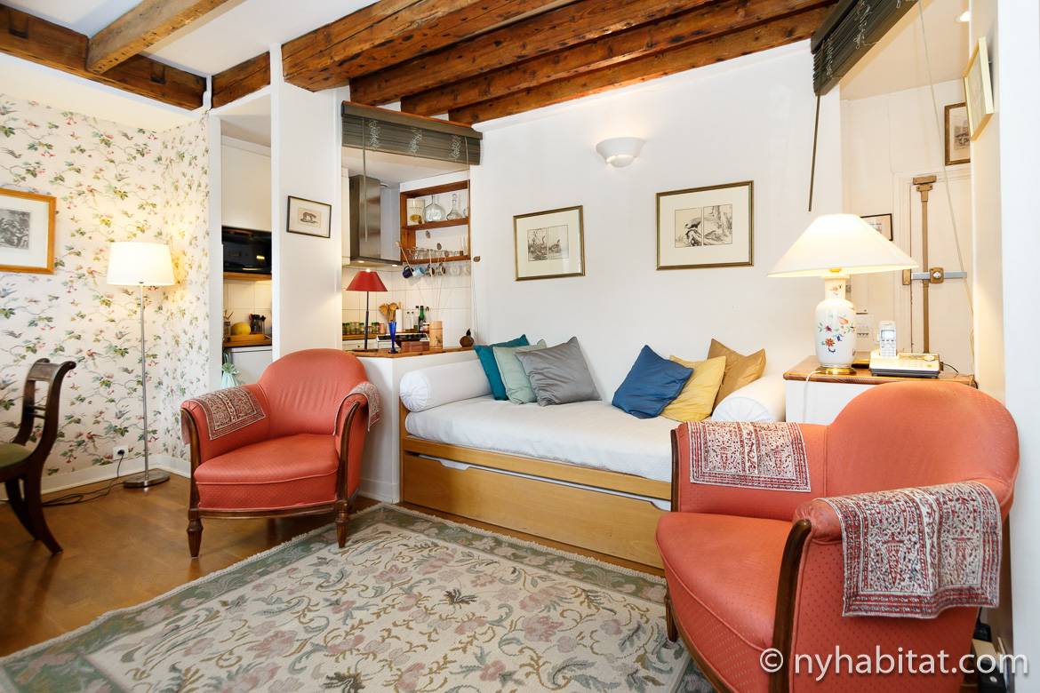 Image of living room of furnished apartment PA-3135 with daybed and exposed wood beam ceilings