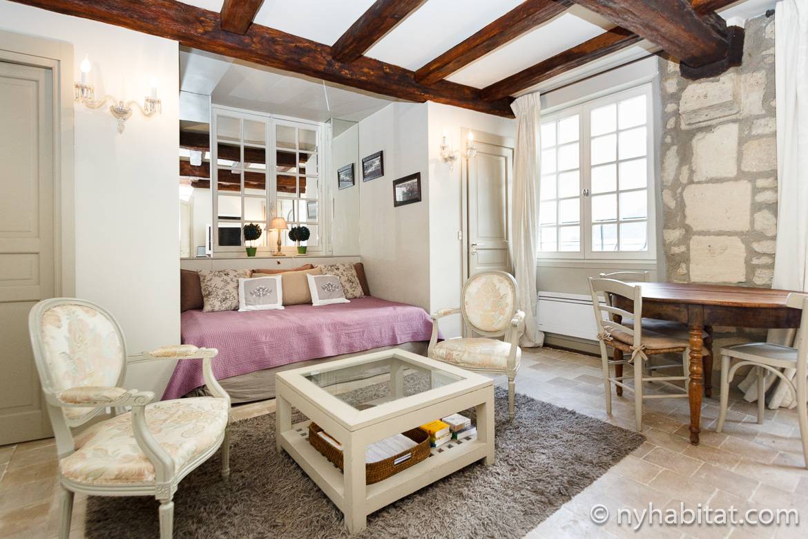 Image of living room of PA-4197 with daybed, exposed stone walls and wood beam ceilings