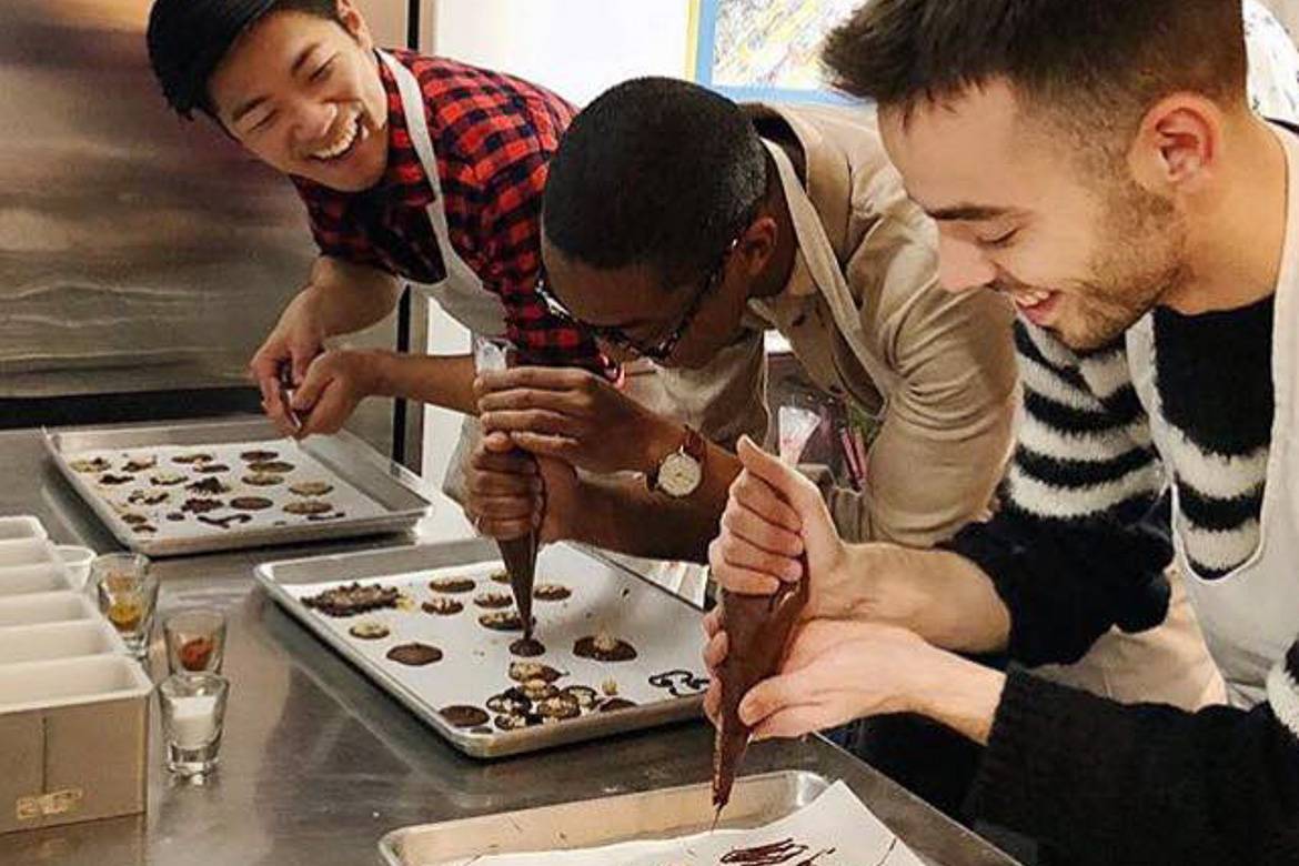 Image of people learning how to make chocolates in a class