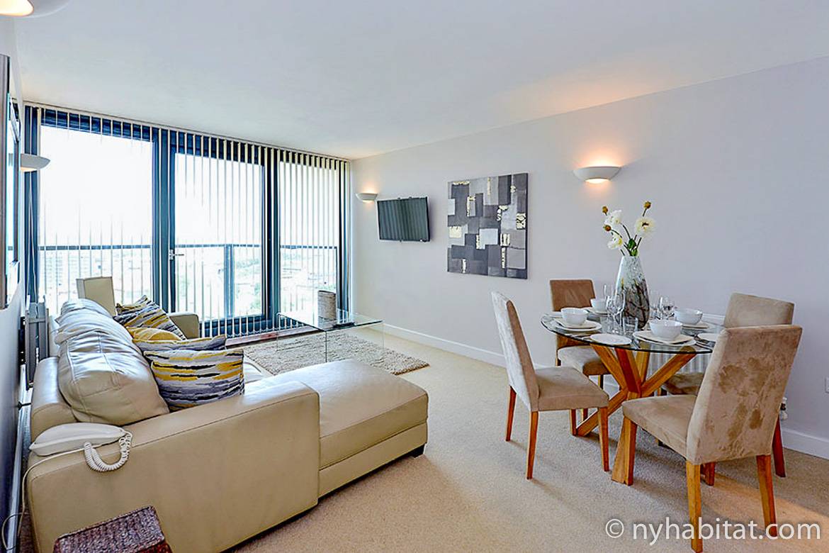 Image of living room of LN-1179 with dining table, sectional sofa, and balcony