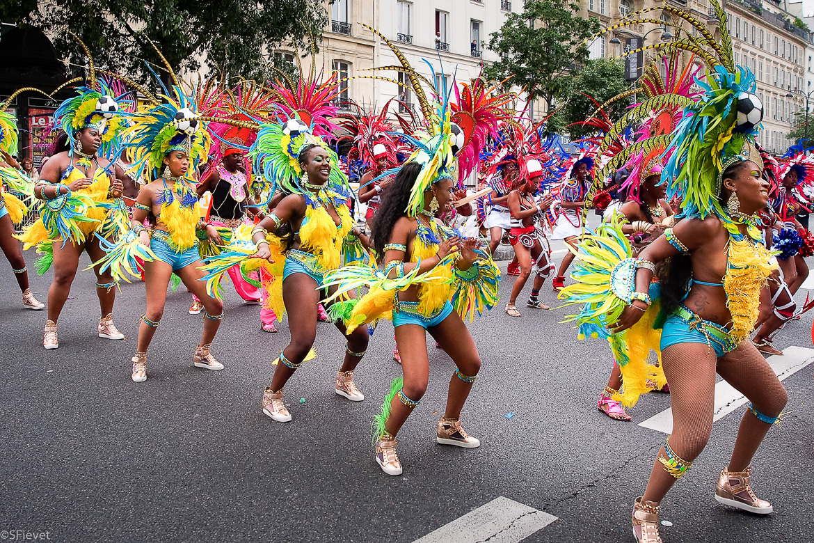 Image of dancers in colorful Caribbean costumes at Champs-Elysées