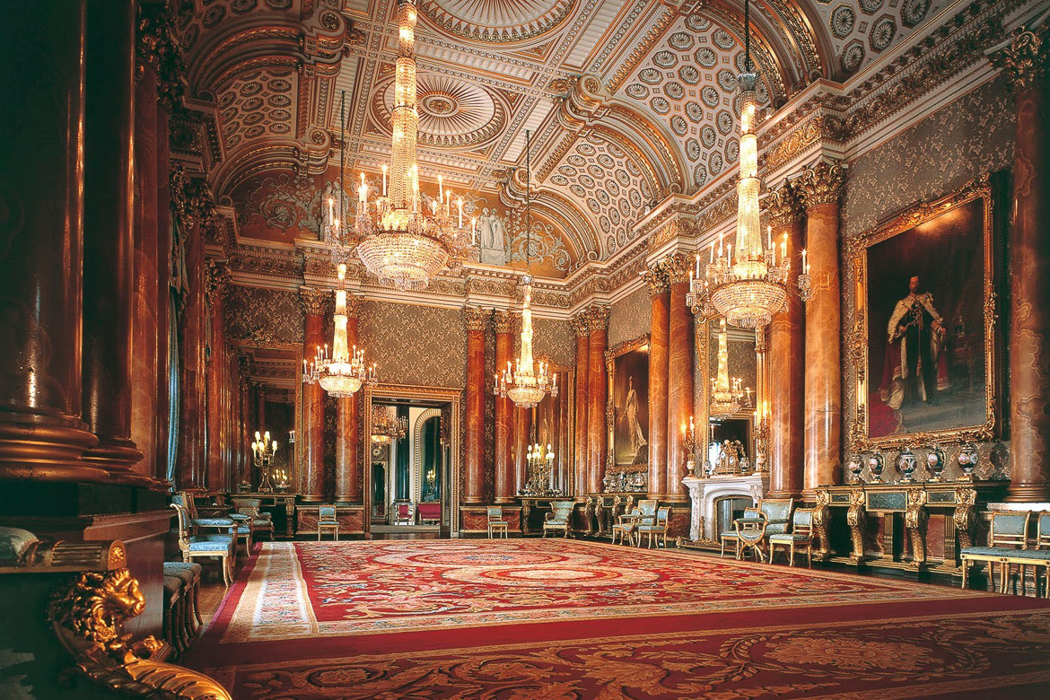 Image of a state room in Buckingham Palace with gilded ceiling and chandeliers