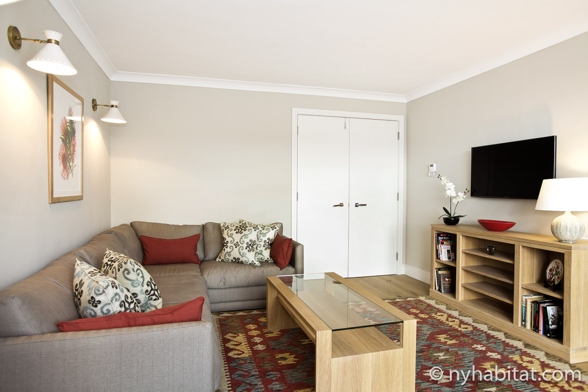 Image of living room in LN-1257 with sofa, television and glass coffee table