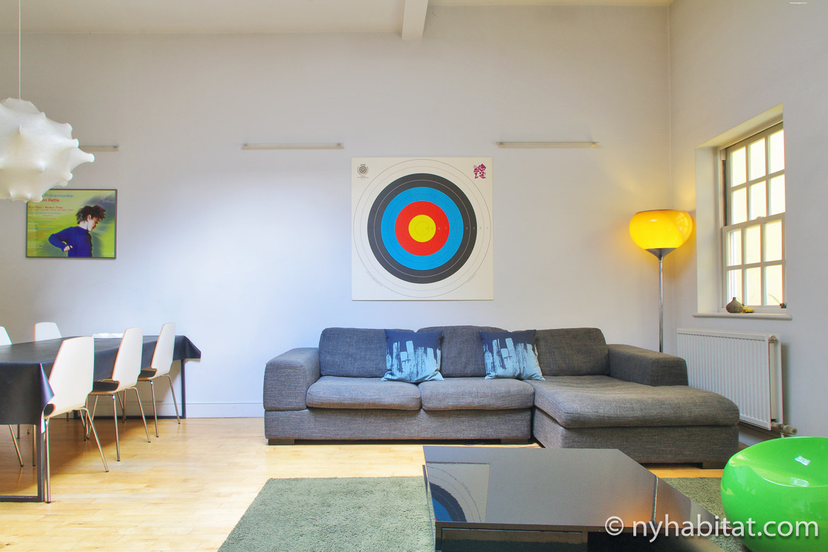 Image of living room in LN-1899 with gray sofa, yellow lamp and wall art