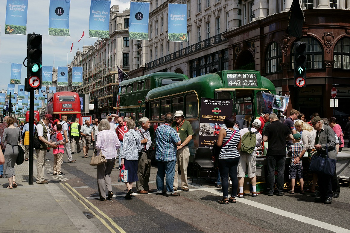 Image of people gathered around double-decker buses during Regent Summer Streets