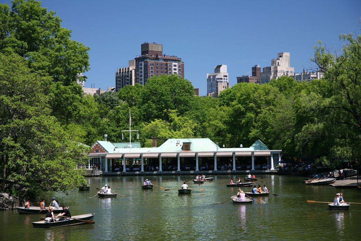 Image of The Lake in Central Park with rowboats and the Loeb Boathouse in the background.