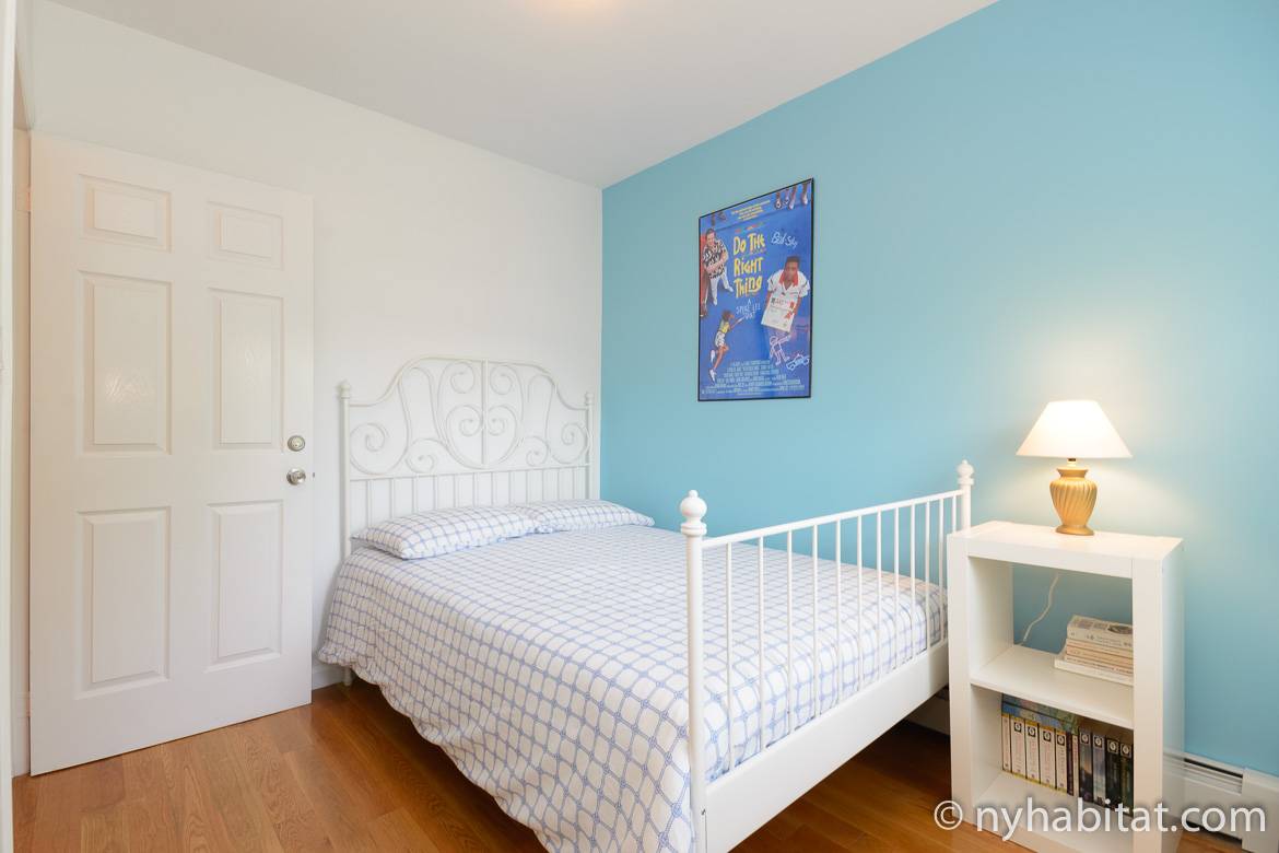 Image of bedroom in NY-16234 with double bed, closet and blue accent wall.