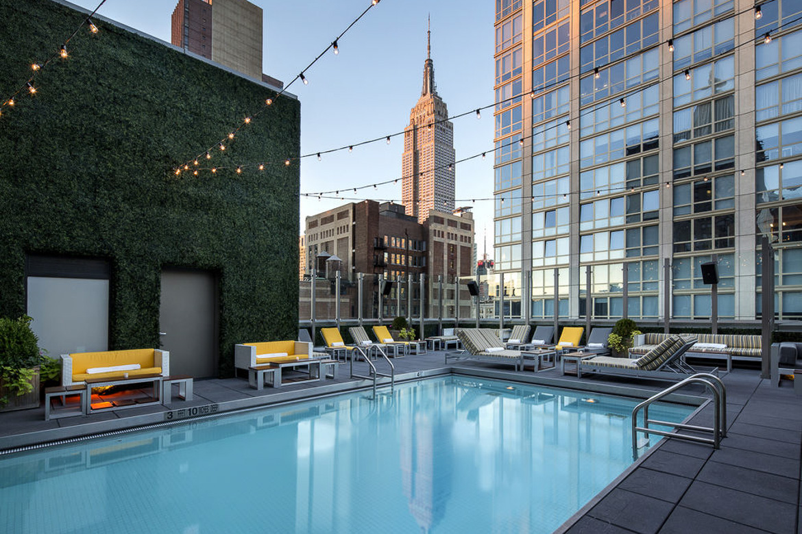 Image of rooftop swimming pool at the Royalton Hotel with Empire State Building in the background