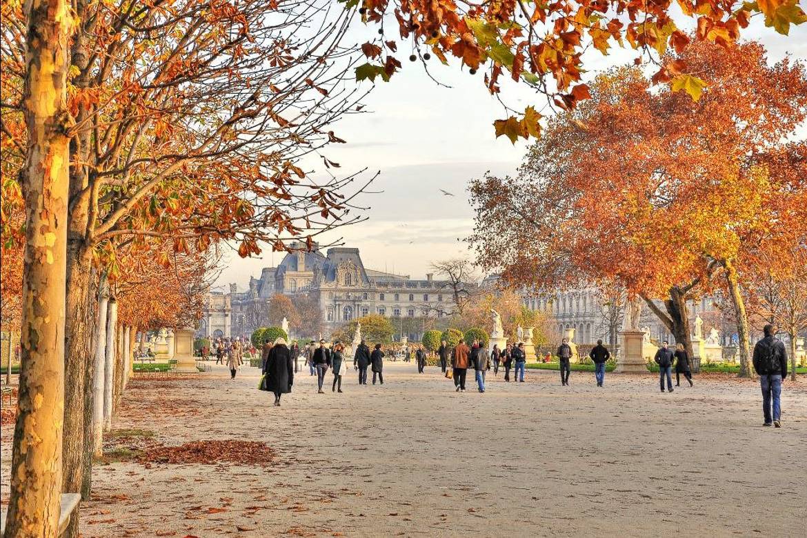 Image of people walking in Tuileries Garden in late autumn.