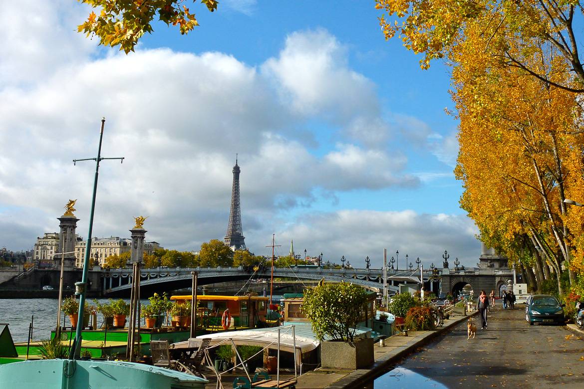 Image of the Seine River with Pont Alexandre and Eiffel Tower in the background in autumn.