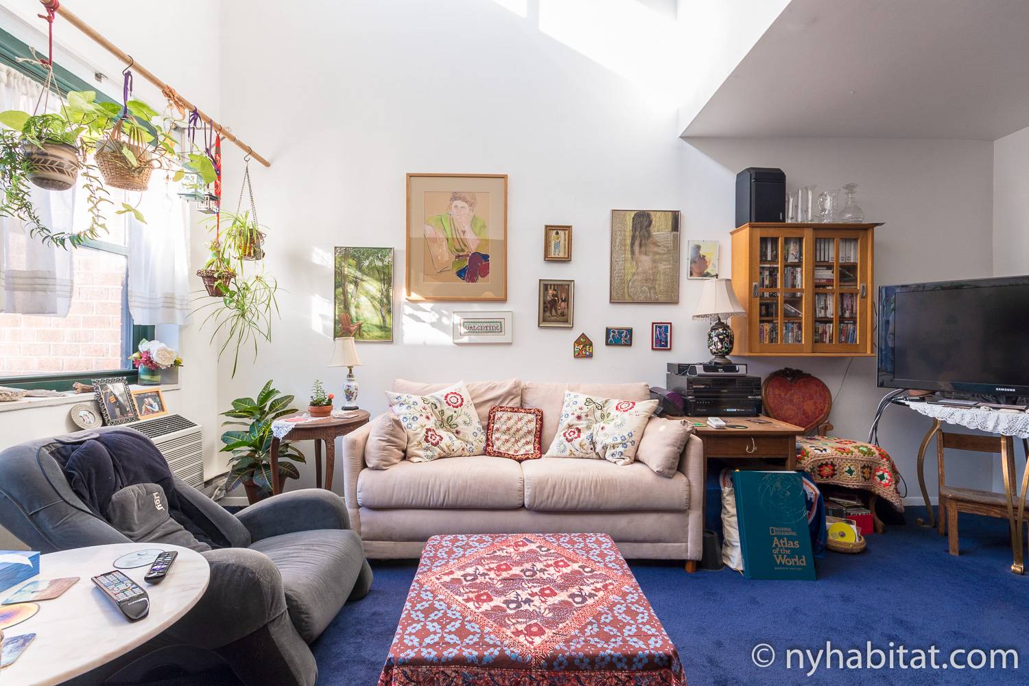 Image of living area in NY-17088 with sofa and artwork.