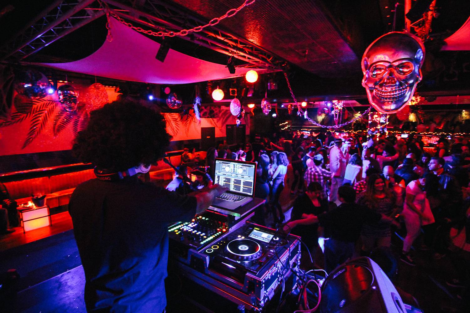 Image of DJ, Halloween decorations and people dancing at Copacabana Nightclub in NYC.