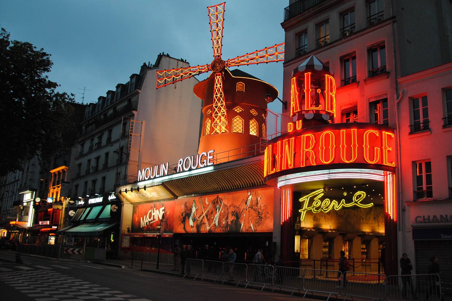Image of the Cabaret Moulin Rouge in Paris lit up with neon signs at night.