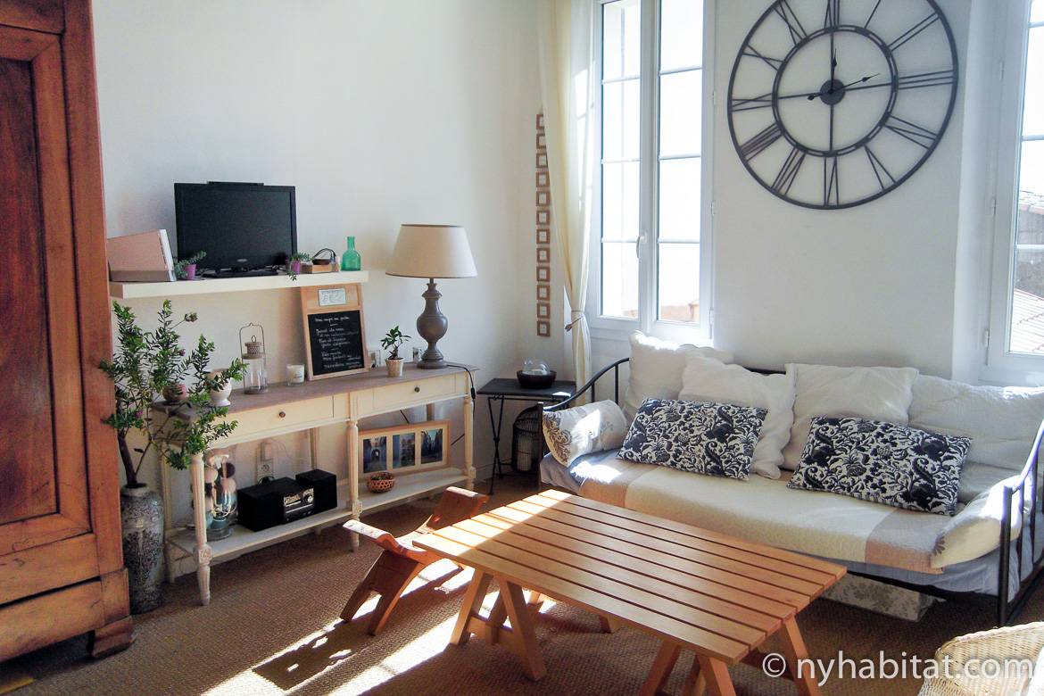 Image of living area in PR-1178 with sofa and wooden table.