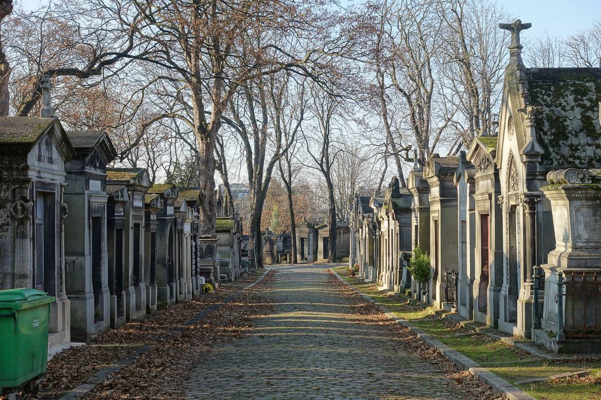 Image of stone path and mausoleum tombs in Père Lachaise Cemetery in Paris.