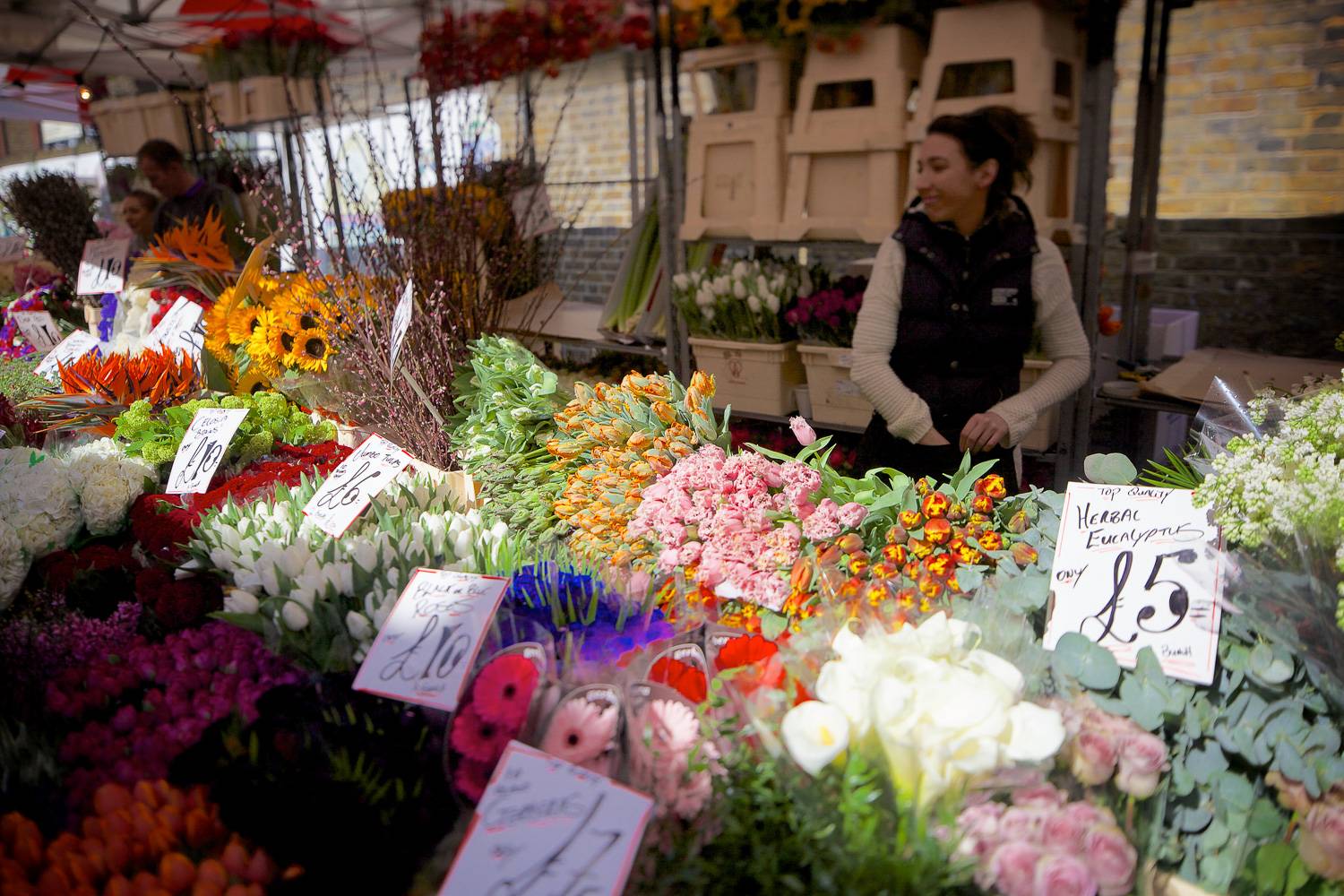 Image of a stall selling flowers at the Columbia Road Flower Market in London.