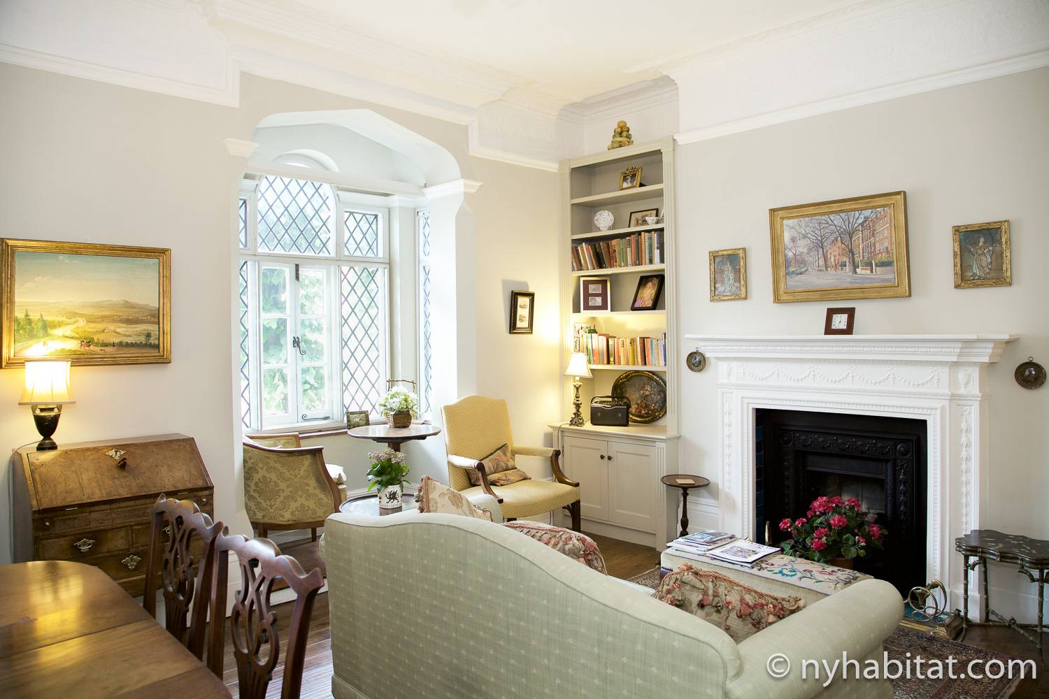 Image of living room of LN-1666 with decorative fireplace, desk, sofa, and chairs.